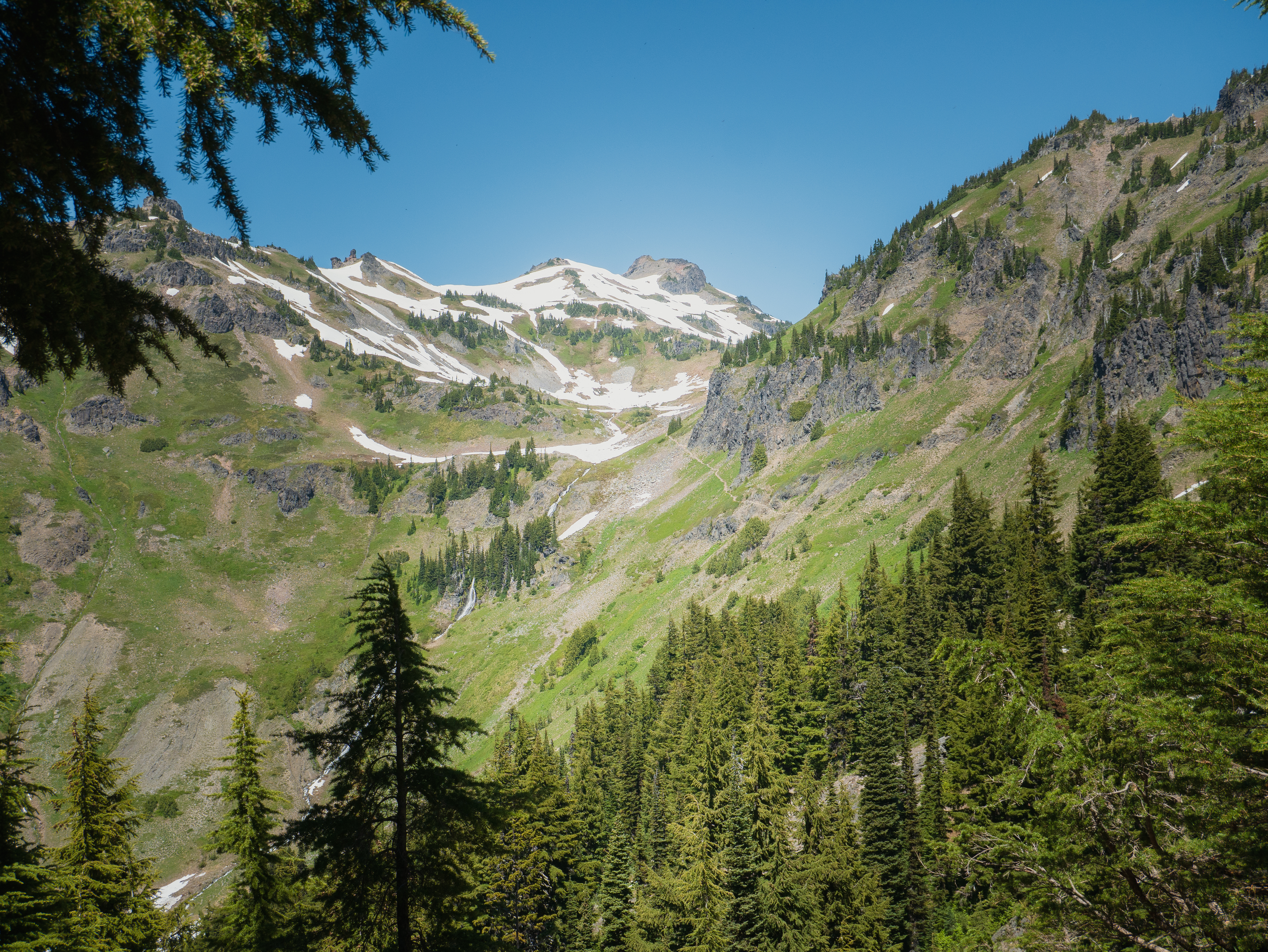 Glacially carved valley in the Goat Rocks Wilderness with snow-capped volcanic peaks