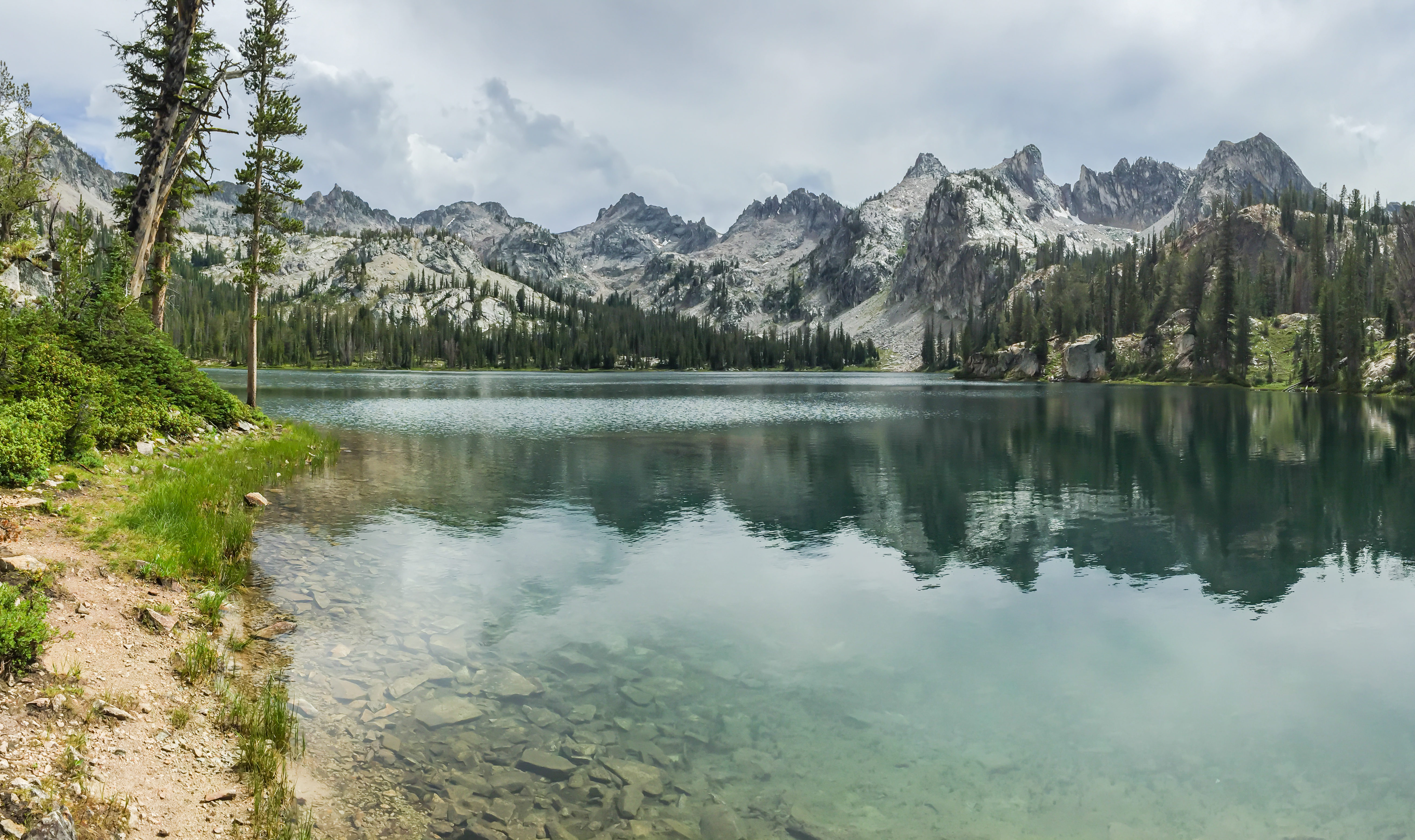 The impossibly clear water of Lake Alice with the Sawtooth peaks reflected on the surface